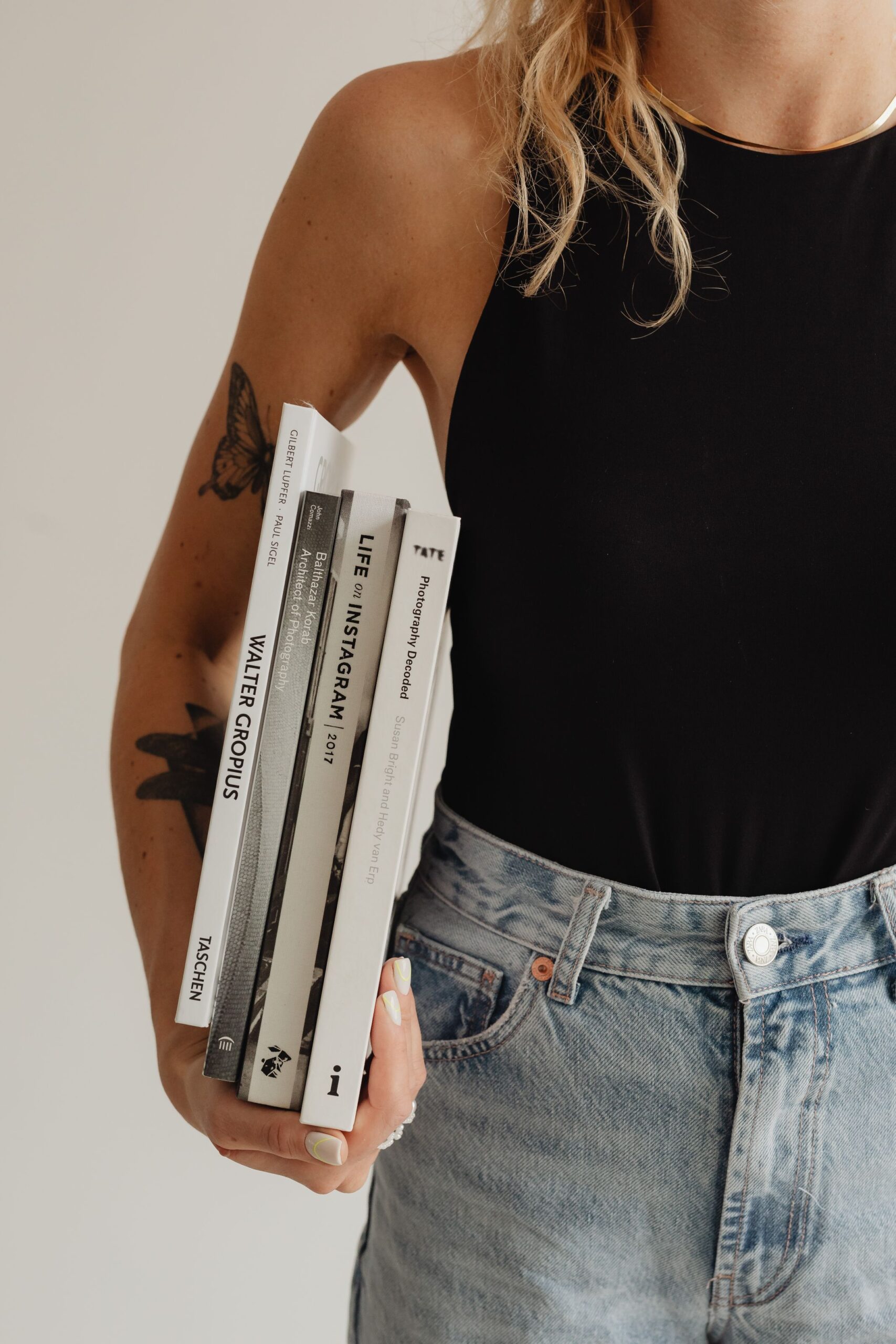 kaboompics_woman-in-light-colored-jeans-with-books-28226
